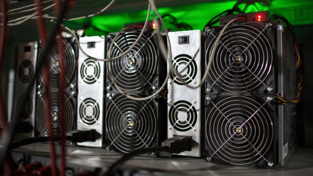 Application-specific integrated circuit (ASIC) devices and power units operate inside a rack at the BitRiver Rus LLC cryptocurrency mining farm in Bratsk, Russia, on Friday, Nov. 8, 2019. Bitriver, the largest data center in the former Soviet Union, was opened just a year ago, but has already won clients from all over the world, including the U.S., Japan and China. Most of them mine bitcoins. Photographer: Andrey Rudakov/Bloomberg