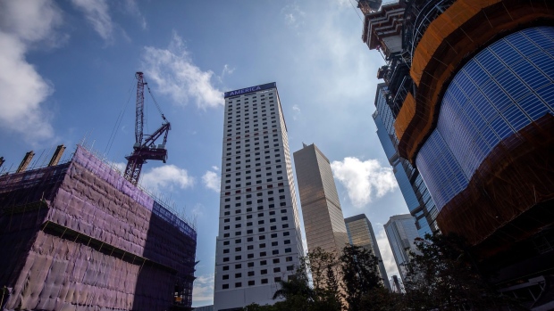 The Cheung Kong Center II commercial building under construction, developed by CK Asset Holdings Ltd., left, the Bank of America Tower, second left, and the Henderson commercial building under construction, developed by Henderson Land Development Co., right, in the Central district of Hong Kong, China, on Monday, Jan. 24, 2022. Vacant office stock in Hong Kong climbed to a record high in December to 9.1 million square feet (845,000 square meters) -- equivalent to nearly 158 football fields, according to real-estate services provider CBRE Group Inc.
