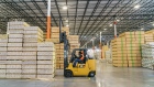 An employee operates a forklift inside the Home Depot flatbed distribution center in Stonecrest, Georgia, U.S., on Tuesday, Nov. 30, 2021. The facility is the centerpiece of Home Depot's plan to ease the complexity of direct-to-consumer sales - and win market share from both its main rival, Lowe’s Cos., and independent distributors.