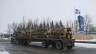 A lumber truck arrives from the U.S. at the border in St-Bernard-de-Lacolle, Quebec, Canada, on Friday, Jan. 14, 2021. Canada plans to start turning away unvaccinated U.S. truckers at the border this weekend, a move that threatens to upend the flow of everything from food to auto parts to building supplies between two of the world's largest trading partners.