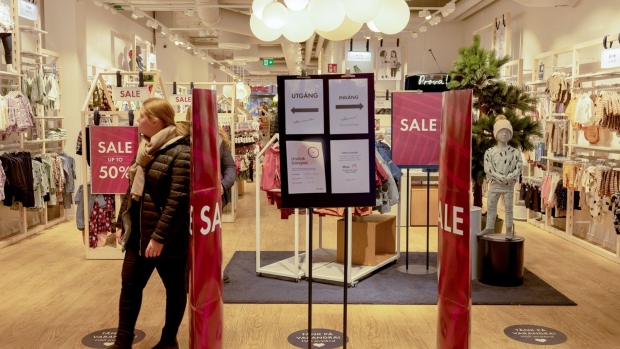 Social distancing signs and a one-way system at children's clothing store in Stockholm. Photographer: Loulou D'Aki/Bloomberg