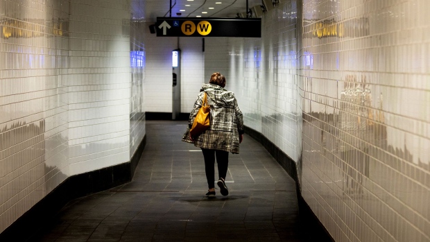 A commuter walks in a subway station in New York, on March 17, 2020.