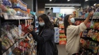 Shoppers wearing protective masks browse inside a convenience store at a Chevron Corp. gas station in Calgary, Alberta, Canada, on Friday, Aug. 14, 2020. Despite a 24% drop in fuel and petroleum product volumes, Parkland Corp., which runs gas stations under the Chevron, Esso, Pioneer and other brands in Canada, posted 12.1% growth in same-store sales at its convenience stores last quarter. Photographer: Leah Hennel/Bloomberg