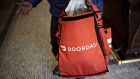 A DoorDash Inc. delivery person holds an insulated bag at Chef Geoff's restaurant in Washington, D.C., U.S., on Thursday, March 26, 2020. As the wheels of government turn too slowly for small businesses desperate for a piece of the $2 trillion U.S. relief package due to the coronavirus pandemic, restaurateur Geoff Tracy is using GoFundMe to raise money for 150 hourly workers at his American comfort food standby Chef Geoff's and other restaurants.