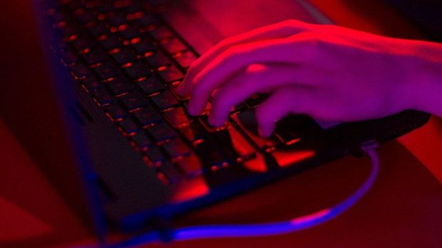 Red light illuminates the keys of a laptop computer.