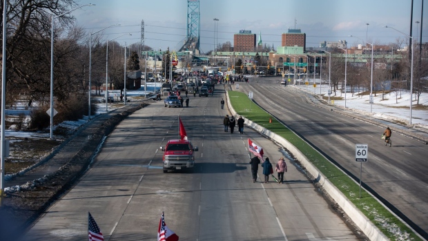 Vehicles and protesters block access to the Ambassador Bridge during a demonstration in Windsor, Ontario, Canada, on Wednesday, Feb. 9, 2022. Protesters blocking traffic between the U.S. and Canada to oppose vaccine rules are further stretching an auto supply chain already worn thin by pandemic-related labor shortages and a scarcity of chips.
