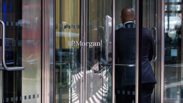 An office worker enters the JPMorgan Chase & Co. headquarters in New York, U.S., on Thursday, July 22, 2021. After a year of Zoom meetings and awkward virtual happy hours, New York's youngest aspiring financiers have returned to the offices of the city's investment banks, where they're making the most of the in-person mentoring and networking they've lacked during the pandemic. Photographer: Michael Nagle/Bloomberg