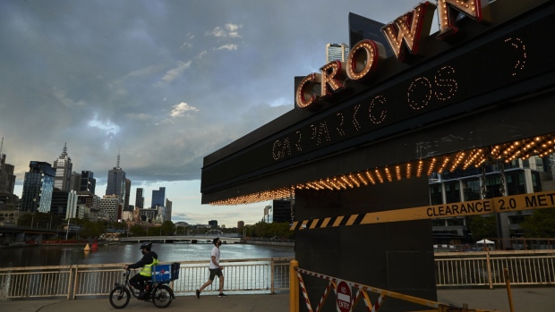 The Crown Resorts Ltd.'s logo outside the company's casino and entertainment complex in Melbourne, Australia, on Thursday, Oct. 14, 2021. Crown’s spectacular fall from a global gambling empire to a reduced chain of domestic casinos stands as one of Australia’s biggest corporate implosions. The humiliation may soon plumb new lows. Photographer: James Bugg/Bloomberg