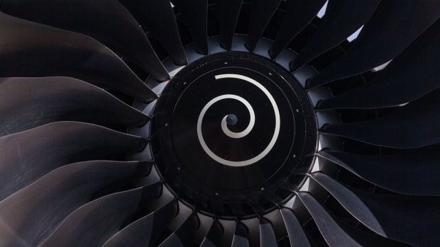 A Rolls Royce Holdings Plc jet engine sits beneath the wing of an Airbus SE A380 passenger jet, operated by Emirates Airline, on static display on the first day of the 16th Dubai Air Show at Dubai World Central (DWC) in Dubai, United Arab Emirates, on Sunday, Nov. 17, 2019. The Dubai Air Show is the biggest aerospace event in the Middle East, Asia and Africa and runs Nov. 17 - 21. Photographer: Christopher Pike/Bloomberg