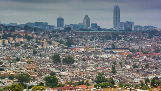Residential shacks in the Alexandra township beneath the Santon skyline in Johannesburg, South Africa, on Thursday, Nov. 12, 2020. Jobs were at the center of a post-virus reconstruction and recovery plan presented by President Cyril Ramaphosa last month, with the government committing 100 billion rand ($6.37 billion) to create public and social employment opportunities. Photographer: Waldo Swiegers/Bloomberg
