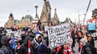 Protesters during a demonstration near Parliament Hill in Ottawa, Ontario, Canada, on Saturday, Feb. 12, 2022. The premier of Canada's biggest province declared a state of emergency, warning protesters choking off traffic at a key U.S. border crossing and causing gridlock in Canada's capital they face stiff punishment if they don't leave.