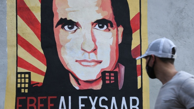 A pedestrian walks past a mural supporting jailed businessman Alex Saab in Caracas, Venezuela, on Friday, Sept. 17, 2021. Saab, a Colombian jailed in Cape Verde for alleged money laundering in his dealings with procuring food goods for a Venezuelan government program, is awaiting extradition to the U.S. after losing multiple appeals.