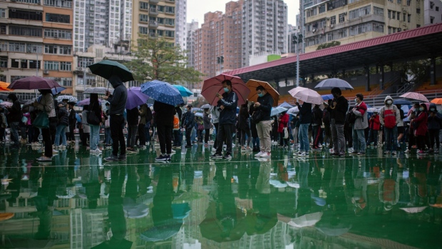 Residents queue at a Covid-19 testing facility in Hong Kong, China, on Thursday, Feb. 17, 2022. Hong Kong is planning a testing blitz of the entire city, deploying a tactic used to root out Covid-19 cases on the mainland as the financial hub struggles to get control over its most challenging outbreak of the pandemic.