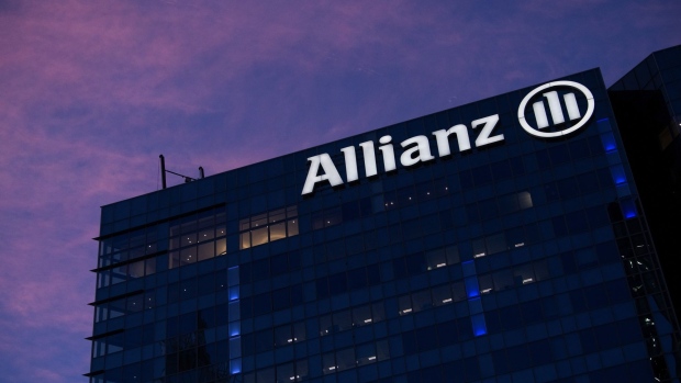 An illuminated Allianz SE logo on the company's offices at dawn in the La Defense business district in Paris, France, on Thursday, Jan. 21, 2021. The shift of jobs and assets to Paris after Brexit will accelerate this year, providing Europe with an opportunity to strengthen its own financial infrastructure, according to Bank of France Governor Francois Villeroy de Galhau.