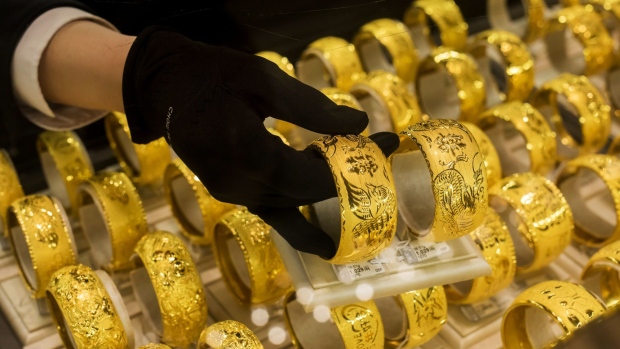 An employee arranges gold bangles inside a Chow Tai Fook Jewellery Group Ltd. jewelry store in Hong Kong, China, on Monday, Jan. 28, 2019. Chow Tai Fook is expecting no sales growth this year compared with the New Year holiday in 2018, according to Managing Director Kent Wong.