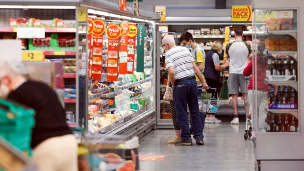 Customers browse a refrigerated aisle of food in a Morrisons supermarket, operated by Wm Morrison Supermarkets Plc, in Saint Ives, U.K., on Monday, July 5, 2021. Apollo Global Management Inc. said Monday it's considering an offer for Morrison, heating up a takeover battle for the U.K. grocer.