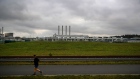 A jogger runs past the Nord Stream 2 gas receiving station in Lubmin, Germany, on Friday, Nov. 12, 2021. Russia’s Nord Stream 2 may need a few more months to clear remaining red tape before the controversial pipeline begins pumping natural gas to Germany to help ease Europe’s energy crunch.