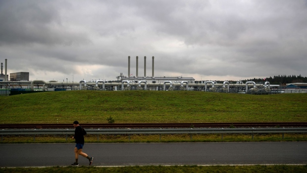 A jogger runs past the Nord Stream 2 gas receiving station in Lubmin, Germany, on Friday, Nov. 12, 2021. Russia’s Nord Stream 2 may need a few more months to clear remaining red tape before the controversial pipeline begins pumping natural gas to Germany to help ease Europe’s energy crunch.