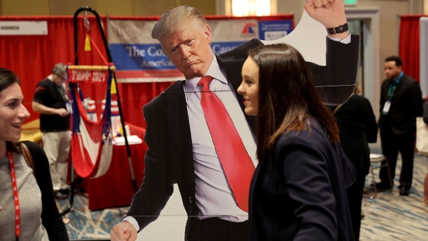 ORLANDO, FLORIDA - FEBRUARY 24: Ellie Kate walks with a cutout of former U.S. President Donald Trump at the Conservative Political Action Conference (CPAC) at The Rosen Shingle Creek on February 24, 2022 in Orlando, Florida. CPAC, which began in 1974, is an annual political conference attended by conservative activists and elected officials. (Photo by Joe Raedle/Getty Images)