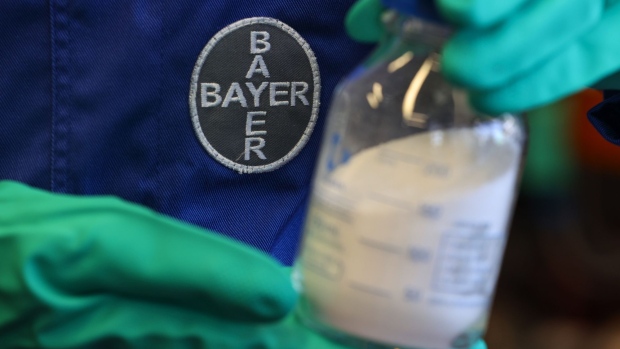 An employee holds a beaker of herbicide compound in the Bayer CropScience AG research and development facility in Frankfurt, Germany, on Monday, July 13, 2020. Germany’s economy continues to recover following the easing of coronavirus-related restrictions, but remains well below capacity, according to a government report.