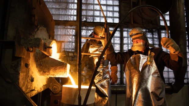 Workers fill a crucible with molten gold during the casting of gold ingots in the foundry at the Prioksky non-ferrous metals plant in Kasimov, Russia, on Thursday, Dec. 9, 2021. Bullion is heading for its first annual drop in three years as central banks start to dial back on pandemic-era stimulus.
