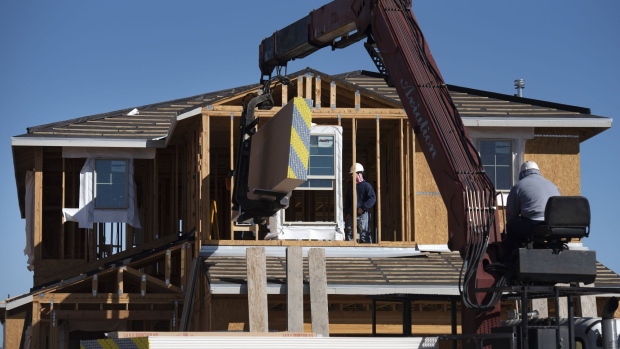 Contractors work on a new home under construction in Tucson, Arizona, U.S., on Tuesday, Feb. 22, 2022. Sales of new U.S. homes retreated in January after a flurry of purchases at the end of 2021, indicating a jump in mortgage rates may be starting to restrain demand. Photographer: Rebecca Noble/Bloomberg