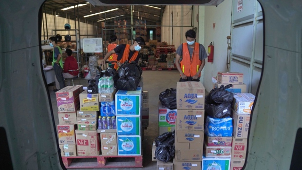 Workers prepare to load a delivery vehicle with orders at a PT Bukalapak.com warehouse in Cikarang, West Java, Indonesia, on Thursday, Sept. 16, 2021. Indonesian e-commerce operator Bukalapak went public in August after raising $1.5 billion in Indonesia’s biggest-ever IPO.