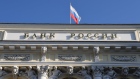 A Russian national flag above the headquarters of Bank Rossii, Russia's central bank, in Moscow, Russia, on Monday, Feb. 28, 2022. The Bank of Russia acted quickly to shield the nation’s $1.5 trillion economy from sweeping sanctions that hit key banks, pushed the ruble to a record low and left President Vladimir Putin unable to access much of his war chest of more than $640 billion.