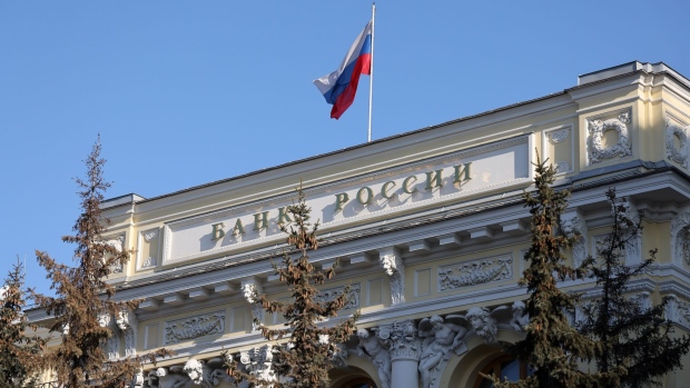 A Russian national flag above the headquarters of Bank Rossii, Russia's central bank, in Moscow, Russia, on Monday, Feb. 28, 2022. The Bank of Russia acted quickly to shield the nation’s $1.5 trillion economy from sweeping sanctions that hit key banks, pushed the ruble to a record low and left President Vladimir Putin unable to access much of his war chest of more than $640 billion.