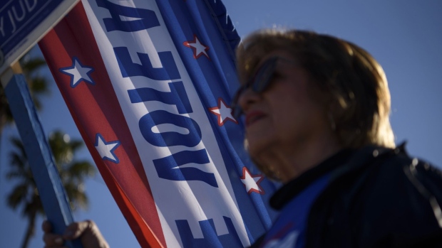 A voter holds a campaign sign during primary elections in Corpus Christi, Texas, U.S., on Tuesday, March 1, 2022. Texas will be one of the most closely watched of 36 governors races happening this year as Democrats including former congressman Beto O’Rourke, Texas Governor Abbott’s likely general-election opponent, try to paint hard-line Republicans as out of touch.
