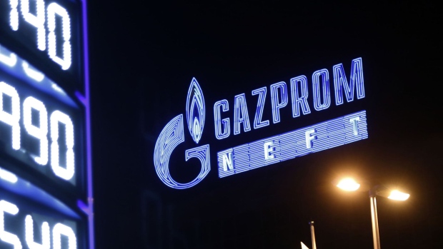 A neon sign displays the Gazprom Neft logo near an illuminated fuel price sign at a Naftna Industrija Srbija AD (NIS) gas station, majority-owned by OAO Gazprom Neft, in Belgrade, Serbia.