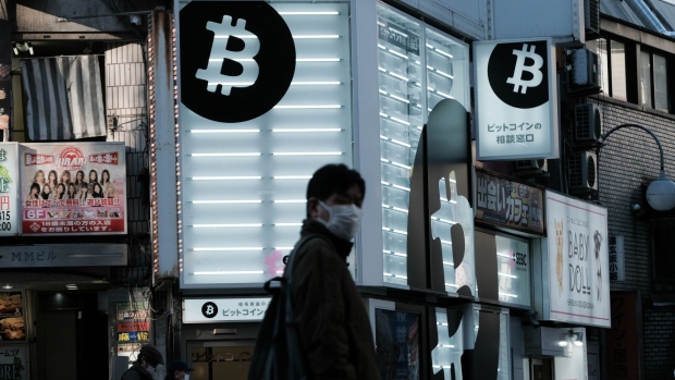 A pedestrian walks past a Sakura Bitcoin Exchange Inc. store in the Shibuya district of Tokyo on Friday, Feb. 25, 2022. Cryptocurrency exchanges are still trying to figure out how to deal with western sanctions against Russia after its invasion of Ukraine. Photographer: Soichiro Koriyama/Bloomberg