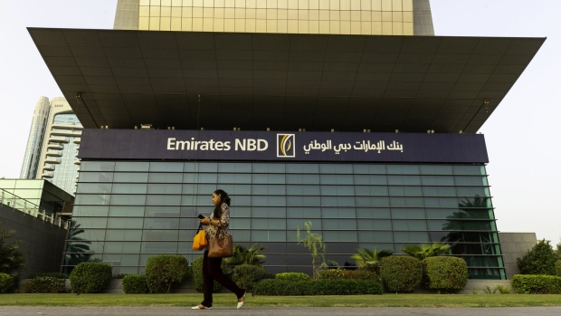 A pedestrian walks past the main office for the Emirates NBD PJSC bank in Dubai, United Arab Emirates, on Tuesday, Sept. 4, 2018. Abu Dhabi is engineering a second bank merger in its latest attempt to stay competitive in the era of lower oil prices.