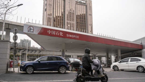 A motorist rides past a China Petroleum & Chemical Corp. (Sinopec) gas station in Shanghai, China, on Thursday, Jan. 7, 2021. China's energy markets are tightening as the economy rebounds and freezing weather grips much of the northern hemisphere, a dynamic that’s likely to be exacerbated by reduced Saudi oil output. Photographer: Qilai Shen/Bloomberg