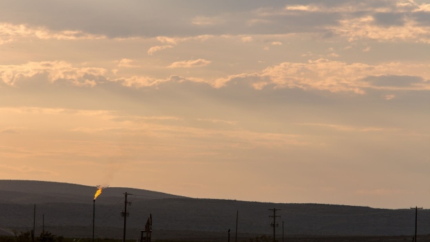 Methane gas is flared just off U.S. Route 285 near Carlsbad, New Mexico, U.S., on Tuesday, Aug. 6. 2019. New Mexico's Governor Michelle Lujan Grisham is balancing her concern over the catastrophic effects of climate change with the state's extraordinary dependence on oil and gas. Photographer: Steven St John/Bloomberg