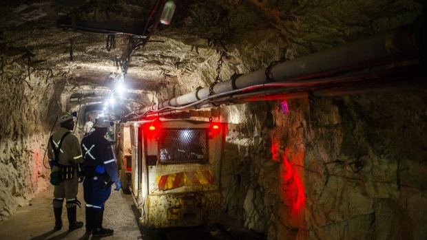 Workers and visitors wait to embark a transportation wagon in the mine shaft during a media tour of the Sibanye-Stillwater Khuseleka platinum mine, operated by Sibanye Gold Ltd., outside Rustenburg, South Africa on Wednesday, Oct. 16 2019. Sibanye said it’s on track to resume paying dividends next year, should the company settle a wage dispute with platinum-mine workers without too much disruption. Photographer: Waldo Swiegers/Bloomberg