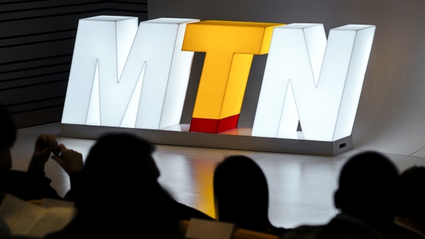 An MTN Group Ltd. sign stands illuminated on stage during a news conference to announce the company's full year results at their headquarters in Johannesburg. Photographer: Waldo Swiegers/Bloomberg