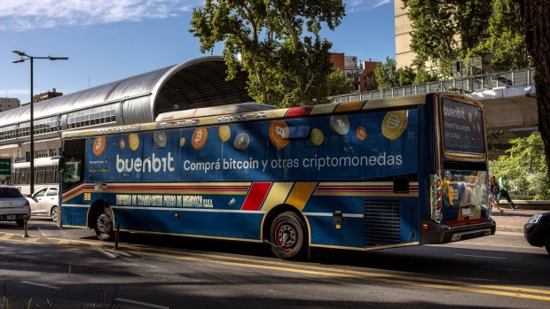 Passengers wait for the Subway under a Satoshitango cryptocurrency exchange publicity in the Palermo neighborhood in Buenos Aires, Argentina, on Thursday, March 3, 2022. Sports stadiums, buses and highway billboards across Argentina are plastered with adverts for cryptocurrency exchanges, as the nation's economic instability fuels one of the world's biggest booms in digital money.