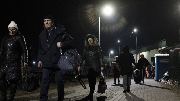 Displaced Ukrainians at the Medyka border crossing in Medyka, Poland, on Tuesday, March 8, 2022. The Polish government announced plans to spend 8 billion zloty ($1.7 billion) on aid to Ukrainian refugees after more than a million people crossed into the country fleeing the war.