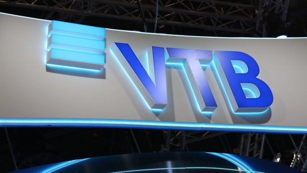 An illuminated logo sits on display above the VTB Bank PJSC pavilion at the St. Petersburg International Economic Forum (SPIEF) in St. Petersburg, Russia, on Friday, June 7, 2019. Over the last 21 years, the Forum has become a leading global platform for members of the business community to meet and discuss the key economic issues facing Russia, emerging markets, and the world as a whole. Photographer: Andrey Rudakov/Bloomberg