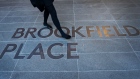 A pedestrian walks across footpath signage for the Brookfield Place Sydney office building, owned and home to the Asia-Pacific headquarters of Brookfields Asset Management Inc., in Sydney, Australia, on Thursday, June 17, 2021. Canadian investment giant Brookfield is bucking the trend when it comes to hybrid work in a post-pandemic world, 90% of staff have been coming in to the headquarters office of Covid-safe Sydney for close to a year, according to Managing Partner Sophi Fallman.
