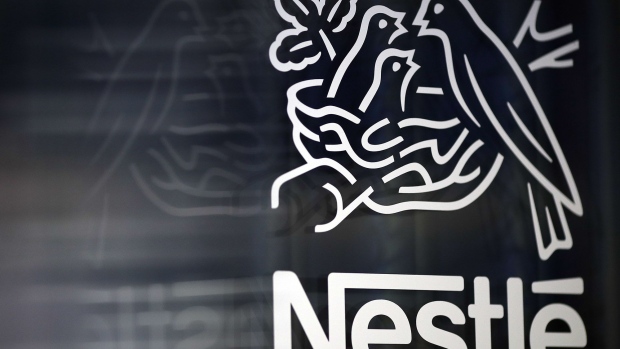 A Nestle birds nest logo is displayed on a glass door ahead of a news conference announcing the company's full year results in Vevey, Switzerland. Photographer: Stefan Wermuth/Bloomberg