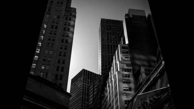 Buildings stand on Wall Street near the New York Stock Exchange (NYSE) in New York, U.S. Photographer: John Taggart/Bloomberg