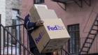 A FedEx courier carries packages during Cyber Monday in the Greenwich Village neighborhood of New York, U.S., on Monday, Nov. 29, 2021. Adobe Digital Economy Index is expecting Cyber Monday to bring the biggest holiday shopping of the year, with consumers projected to spend between $10.2 billion and $11.3 billion.