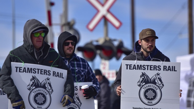 Workers demonstrate during a Canadian Pacific Railway strike in Calgary, Alberta, Canada, on Sunday, March 20, 2022. Canadian Pacific Railway entered a work stoppage early Sunday after the company and the union's leadership were unable to negotiate a settlement or agree to binding arbitration.
