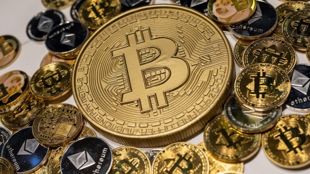 Novelty Bitcoin, Ethereum and Dodgecoin tokens arranged at a CoinUnited cryptocurrency exchange in Hong Kong, China, on Friday, March 4, 2022. Bitcoin fell below $38,000 on March 8, touching its lowest price in a week, as global markets tumbled on concerns that spiraling commodities prices unleashed by Russia's invasion of Ukraine may have a wider and longer-lasting impact than previously thought. Photographer: Paul Yeung/Bloomberg