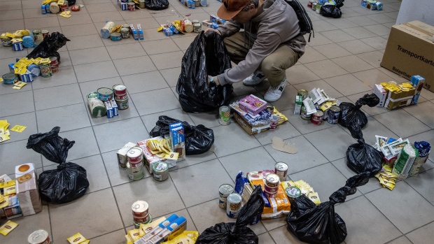KYIV, UKRAINE - MARCH 19: A volunteer works to make food packages from donated goods from European countries to distribute to cities around Kyiv at an aid center on March 19, 2022 in Kyiv, Ukraine. Russian forces remain on the outskirts of the Ukrainian capital, but their advance has stalled in recent days, even while Russian strikes - and pieces of intercepted missiles - have hit residential areas in the north of Kyiv. An estimated half of Kyiv's population has fled to other parts of the country, or abroad, since Russia invaded on February 24. (Photo by Chris McGrath/Getty Images)