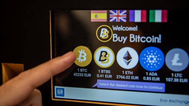 A customer selects Bitcoin for purchase on the screen of a cryptocurrency automated teller machine (ATM) in Barcelona, Spain, on Wednesday, March 9, 2022. Bitcoin dropped back below $40,000, erasing almost all the gains sparked by optimism about U.S. President Joe Biden’s executive order to put more focus on the crypto sector. Photographer: Angel Garcia/Bloomberg