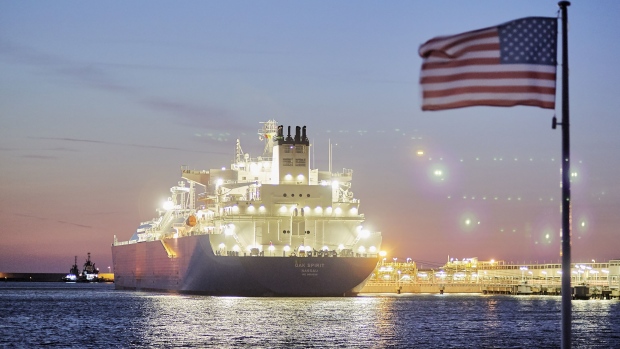 The U.S. national flag flies as the liquefied natural gas (LNG) tanker Oak Spirit, operated by Teekay Corp., sits docked with Poland's first import of U.S. LNG at the Gazoport terminal, operated by Polskie LNG SA, in Swinoujscie, Poland, on Thursday, July 25, 2019. More "freedom gas" from U.S. shale basins is earmarked for Europe after the company behind a Louisiana export project expanded a deal with Poland.