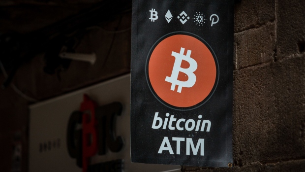 A Bitcoin automated teller machine (ATM) sign outside a cryptocurrency exchange in Barcelona, Spain, on Wednesday, March 9, 2022. Bitcoin dropped back below $40,000, erasing almost all the gains sparked by optimism about U.S. President Joe Biden’s executive order to put more focus on the crypto sector. Photographer: Angel Garcia/Bloomberg